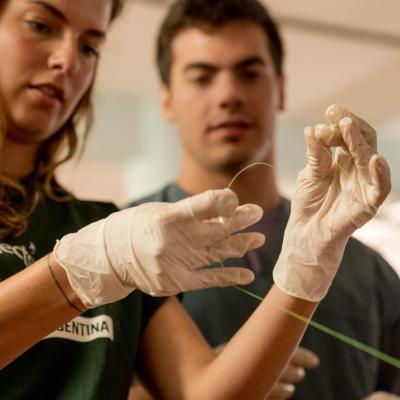 A medical intern is taught how to tie a suture at a workshop during her medical internship in Argentina. Female Projects Abroad Medicine intern learns how to tie a sature at a hopsital as part of her medical work experience in Argentina.